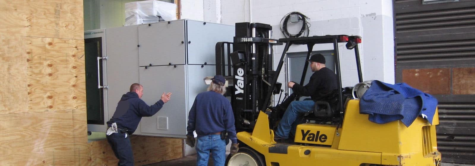 Champagne Logistics shipping team guiding forklift