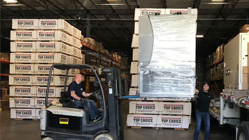 Champagne Logistics shipping team guiding forklift 2